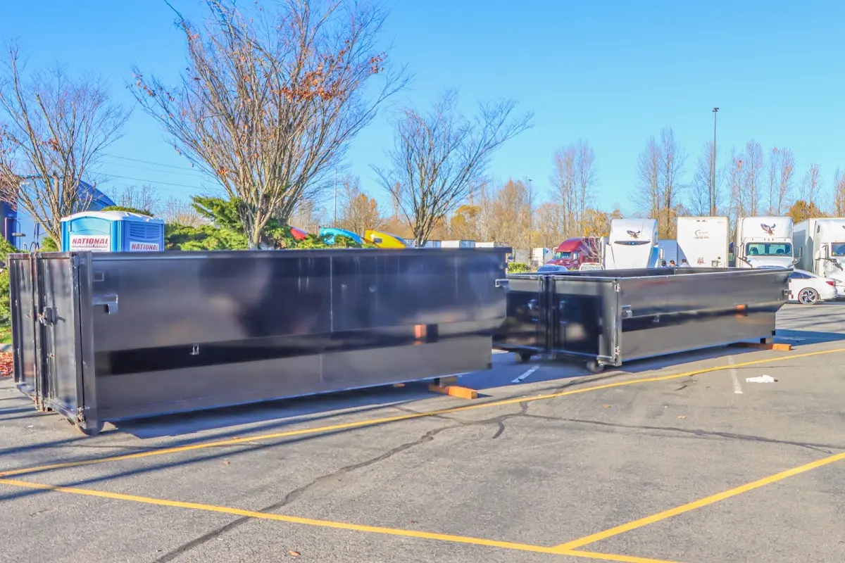 Professional dumpster rental service with roll-off container on residential driveway in Norristown
